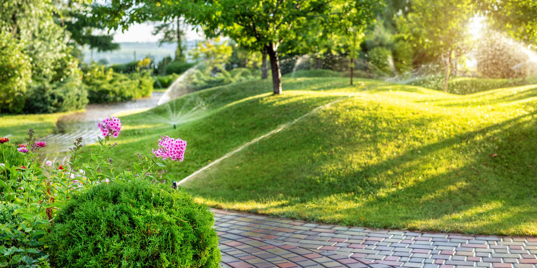 Sprinklers on a beautiful path and lanscape